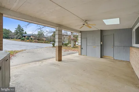 a view of a hallway with furniture and wooden floor