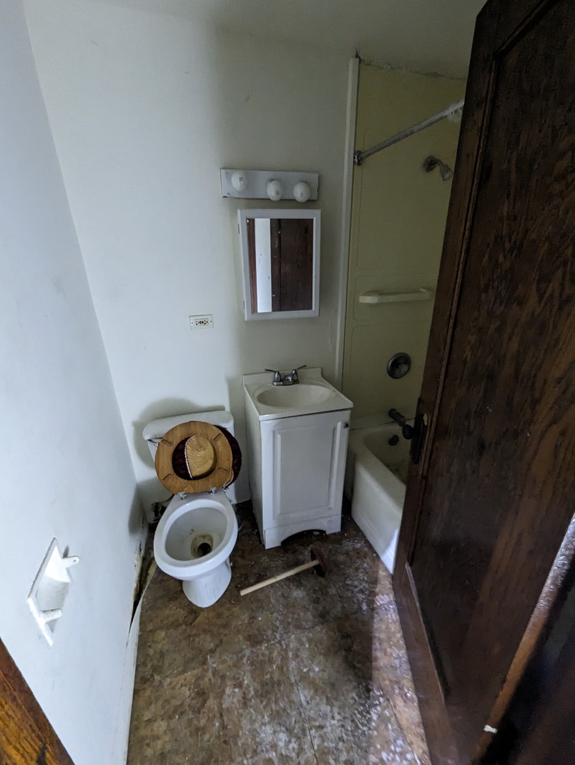 7157 South Yale Avenue Chicago, IL 60621 - Photo 7 of 8 a bathroom with a sink and toilet