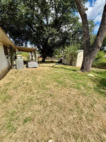 a view of a yard with large trees