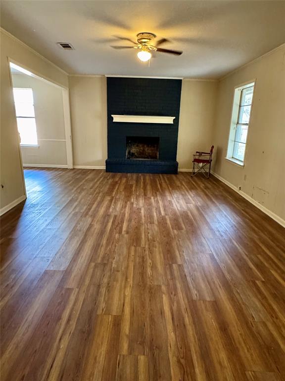 708 Meadow Lane Mexia, TX 76667 - Photo 2 of 11 wooden floor fireplace and natural light