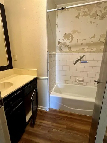 a bathroom with a bathtub and shower