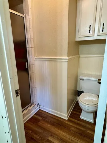 a bathroom with a toilet and a shower