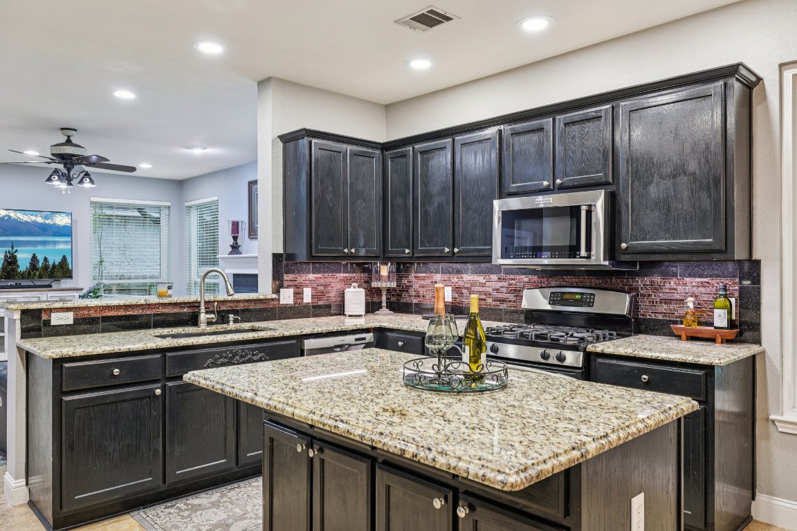 1108 Dalea Bluff Round Rock, TX 78665 - Photo 11 of 40 a kitchen with a stove and a microwave