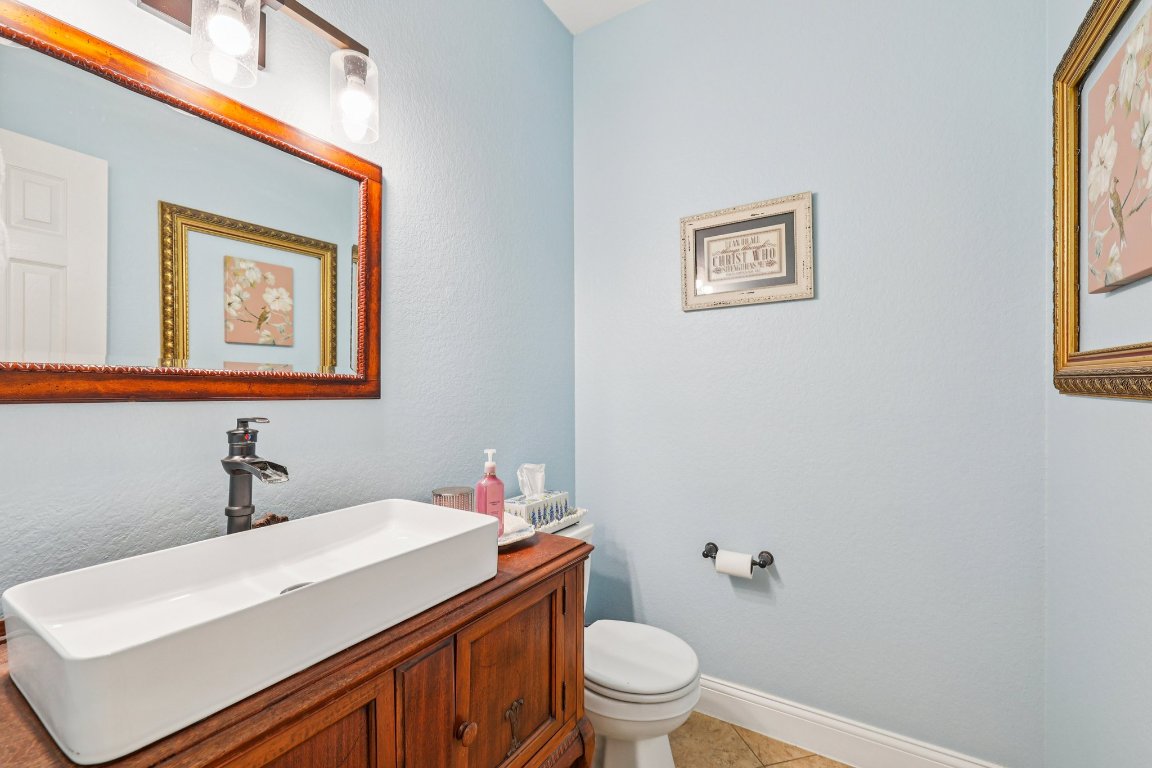 1108 Dalea Bluff Round Rock, TX 78665 - Photo 18 of 40 a bathroom with a sink mirror vanity and a toilet