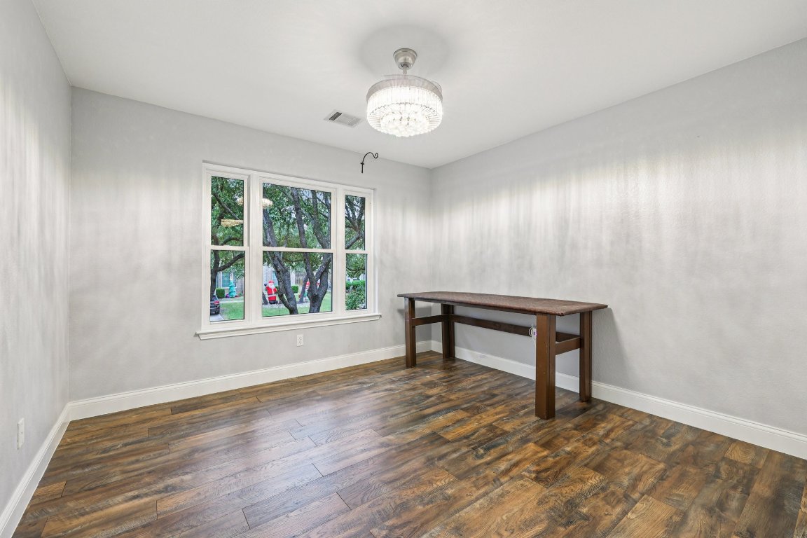 1108 Dalea Bluff Round Rock, TX 78665 - Photo 20 of 40 a view of an empty room with a window and wooden floor