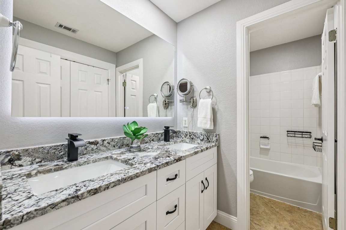 1108 Dalea Bluff Round Rock, TX 78665 - Photo 25 of 40 a bathroom with a granite countertop sink and a mirror