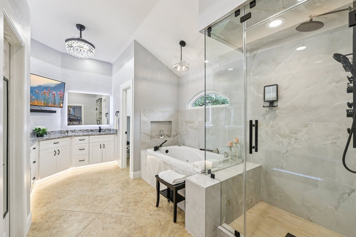 1108 Dalea Bluff Round Rock, TX 78665 - Photo 29 of 40 a large bathroom with a sink a toilet a mirror and shower