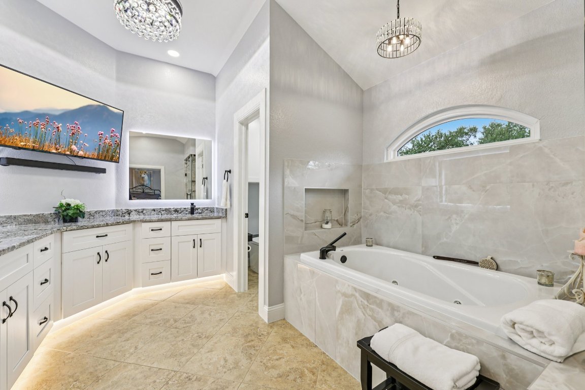 1108 Dalea Bluff Round Rock, TX 78665 - Photo 30 of 40 a spacious bathroom with a tub double sink and a mirror