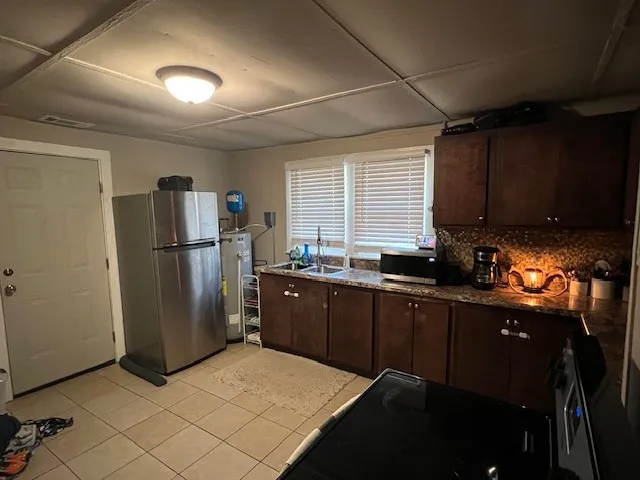 a kitchen with a refrigerator and a sink