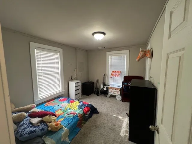 a bedroom with a bed and a window