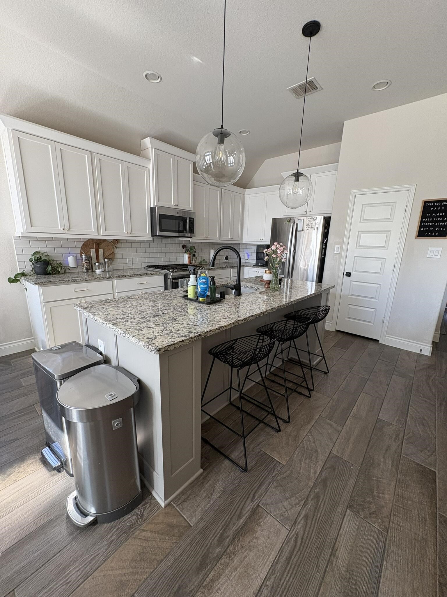 2231 Blackhawk Ridge Lane Manvel, TX 77578 - Photo 3 of 12 a kitchen with stainless steel appliances granite countertop a kitchen island a stove a sink a dining table and chairs