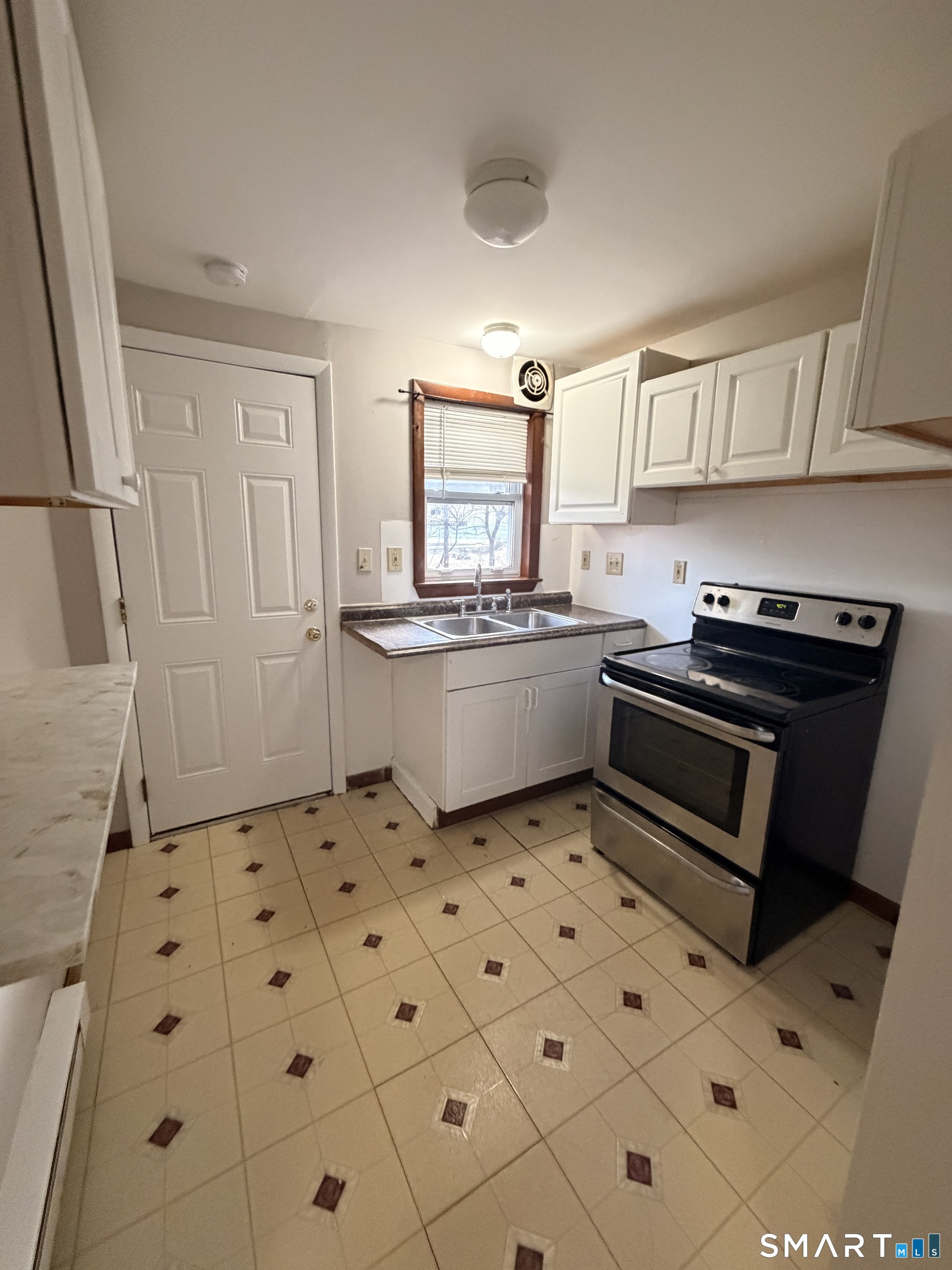 844 Field Street Naugatuck, CT 06770 - Photo 5 of 6 a kitchen with granite countertop a stove a sink and a refrigerator