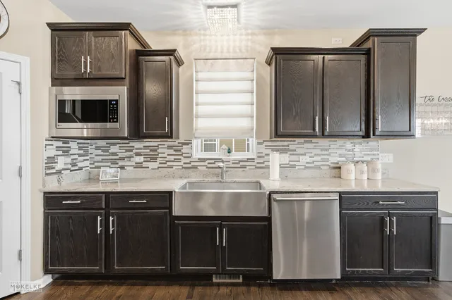 a kitchen with granite countertop a sink and cabinets