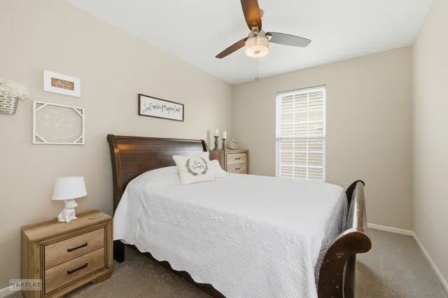 a bedroom with a bed and with a window