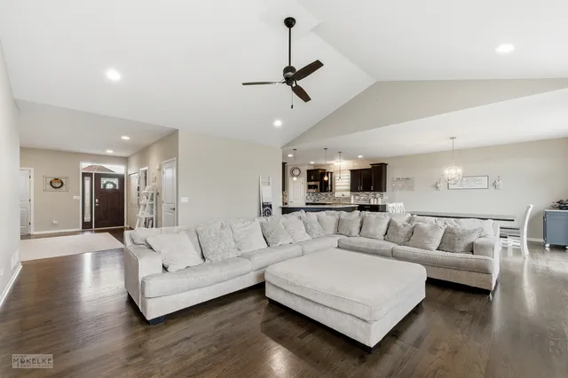 a living room with furniture and a chandelier