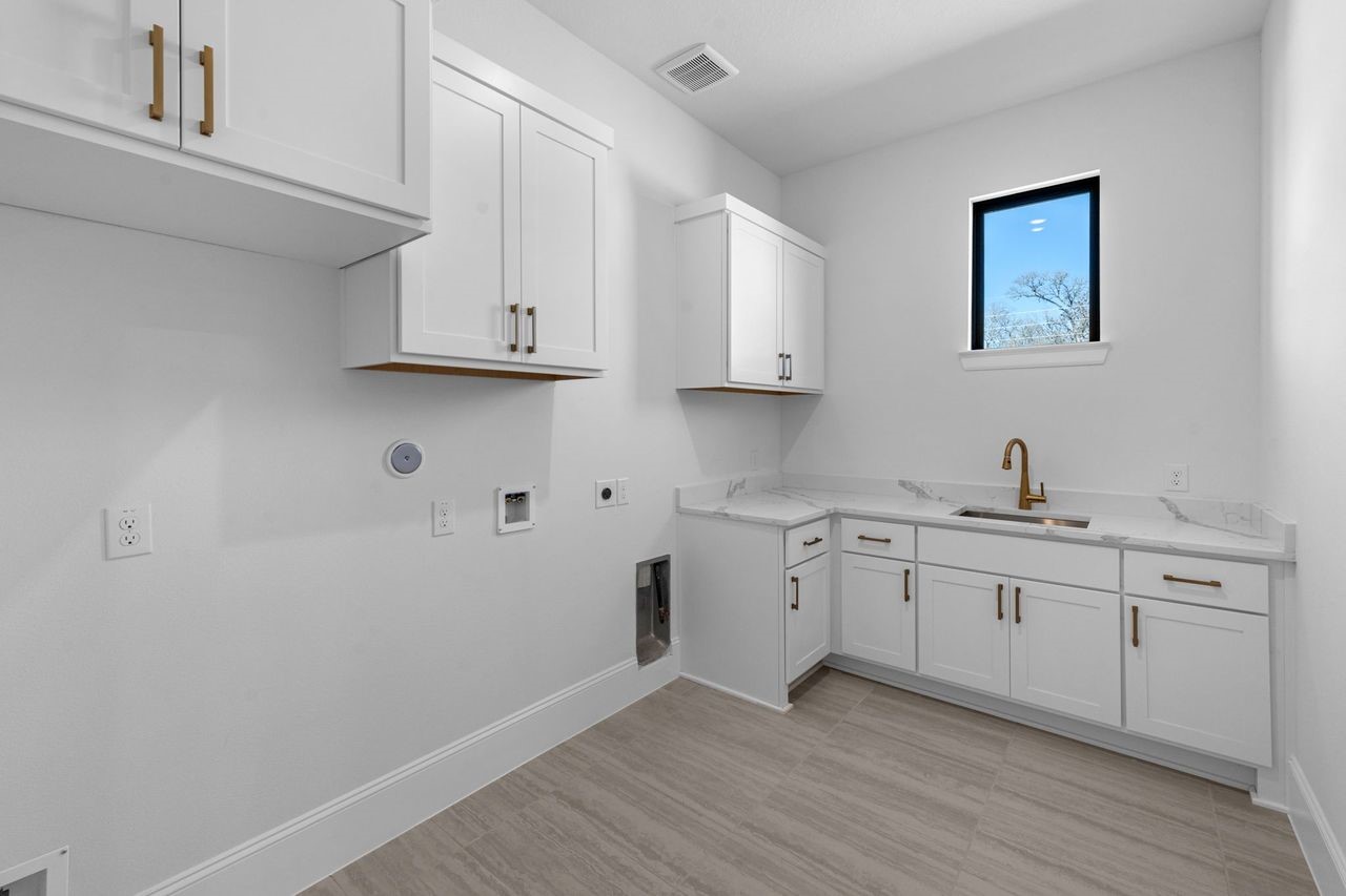 7703 Sparkle Dunn Court Fulshear, TX 77441 - Photo 18 of 26 I love the sink in the laundry room and the window! There is a second laundry room upstairs!