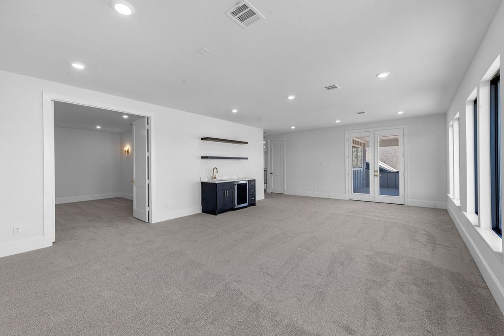 7703 Sparkle Dunn Court Fulshear, TX 77441 - Photo 22 of 26 Game room with a beverage center, media room and a balcony