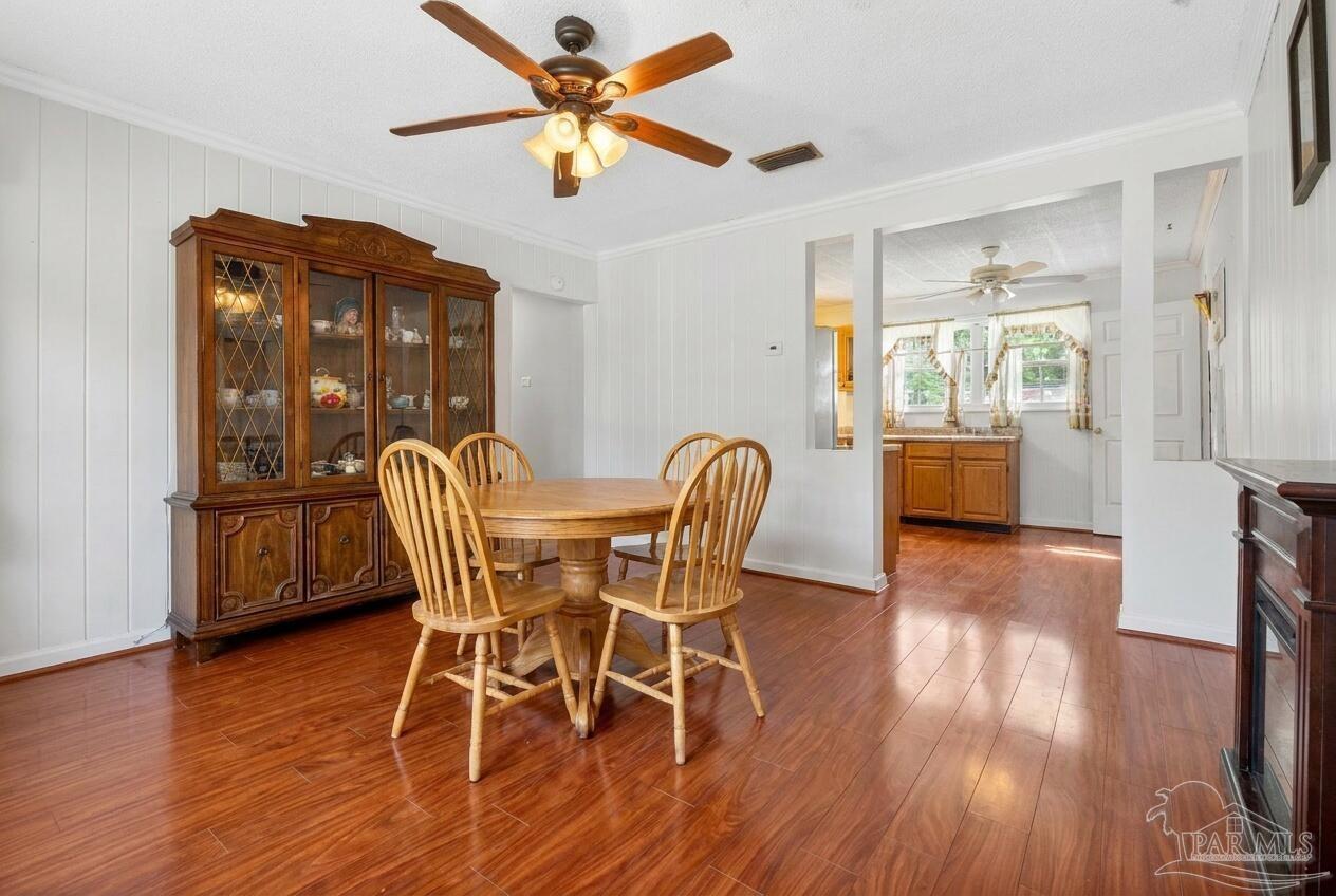 6253 Allentown Road Milton, FL 32570 - Photo 6 of 31 a view of a dining room with furniture window and wooden floor