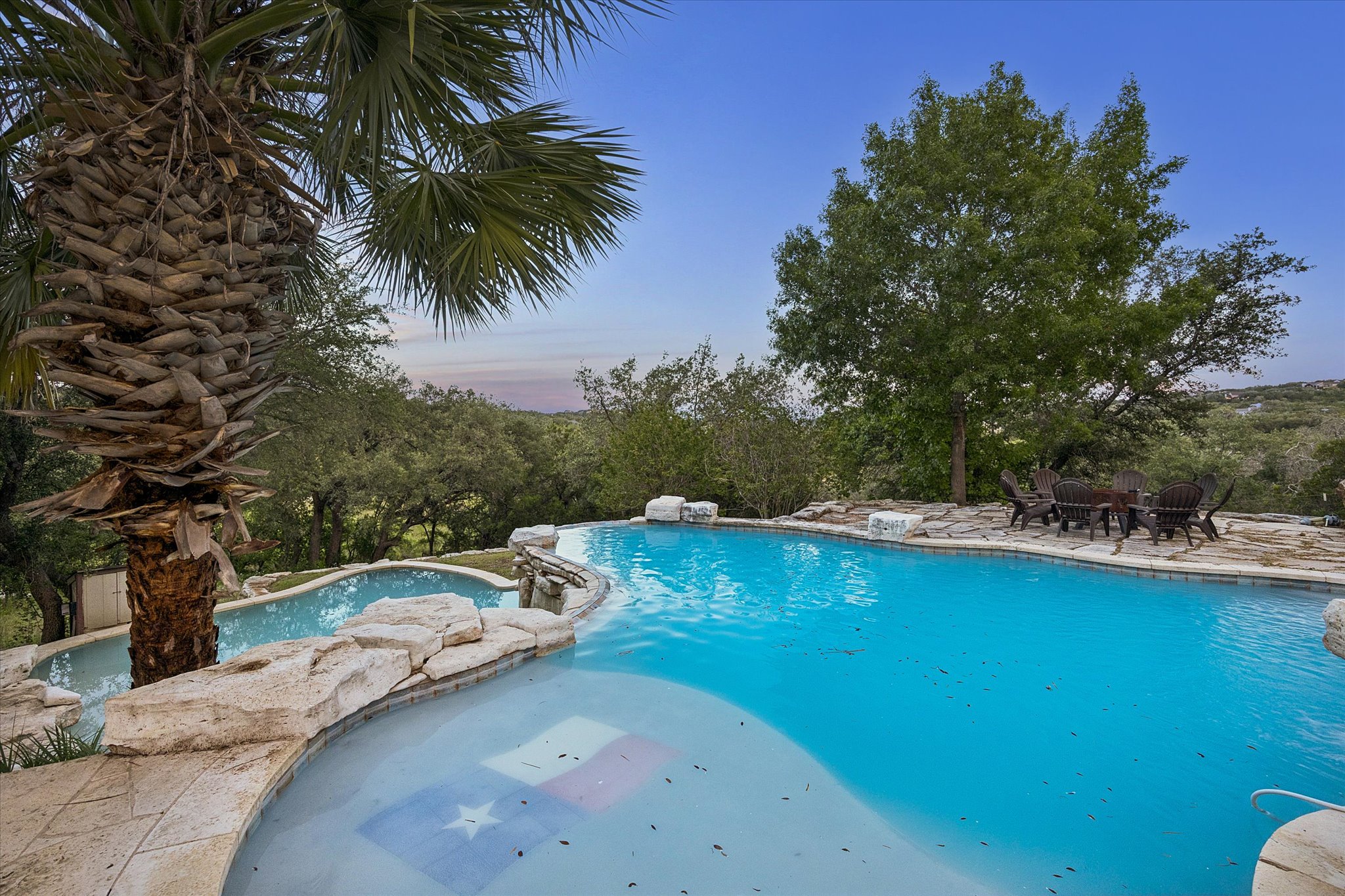 3719 Bee Creek Road Spicewood, TX 78669 - Photo 30 of 40 A tranquil oasis features a sprawling in-ground pool and an elevated spa overlooking a verdant landscape.