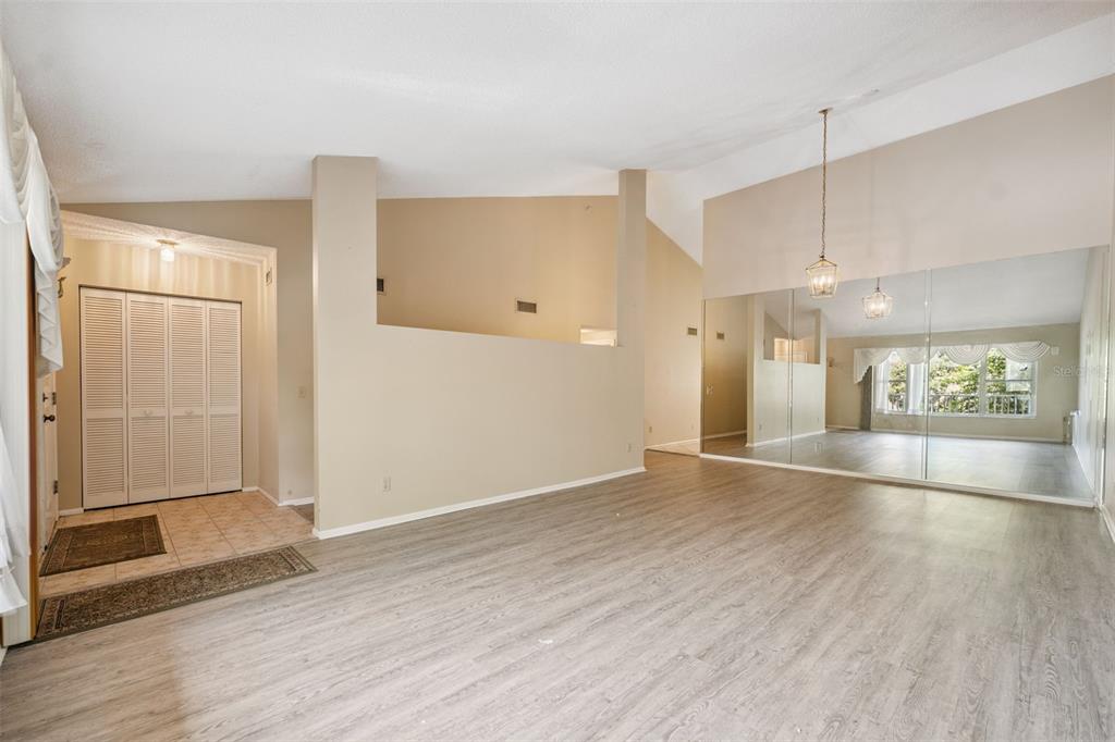 2192 Swedish Drive, Unit 26 Clearwater, FL 33763 - Photo 11 of 49 an empty room with wooden floor and windows