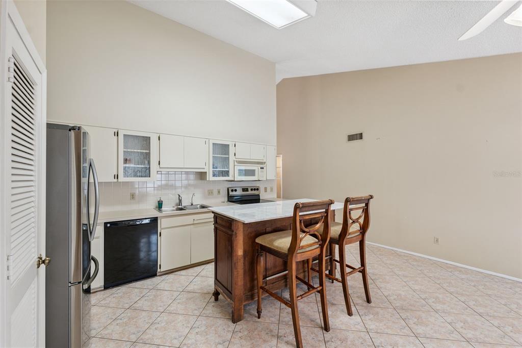 2192 Swedish Drive, Unit 26 Clearwater, FL 33763 - Photo 16 of 49 a kitchen with a table and chairs in it