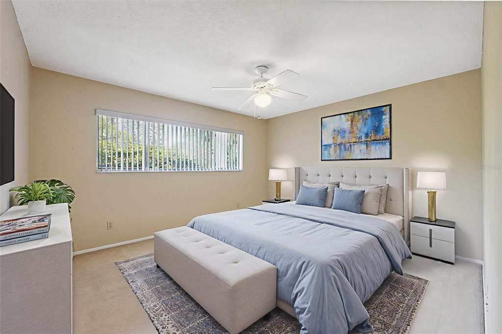 2192 Swedish Drive, Unit 26 Clearwater, FL 33763 - Photo 26 of 49 a bedroom with a bed and a chandelier