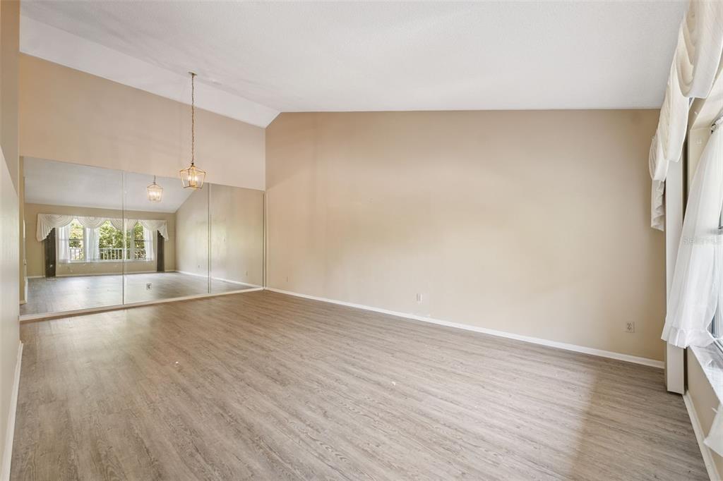 2192 Swedish Drive, Unit 26 Clearwater, FL 33763 - Photo 7 of 49 a view of empty room with wooden floor and fan