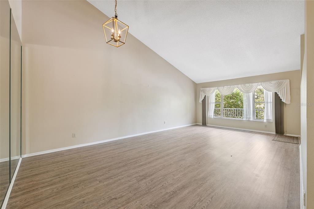 2192 Swedish Drive, Unit 26 Clearwater, FL 33763 - Photo 9 of 49 a view of an empty room with wooden floor and a window