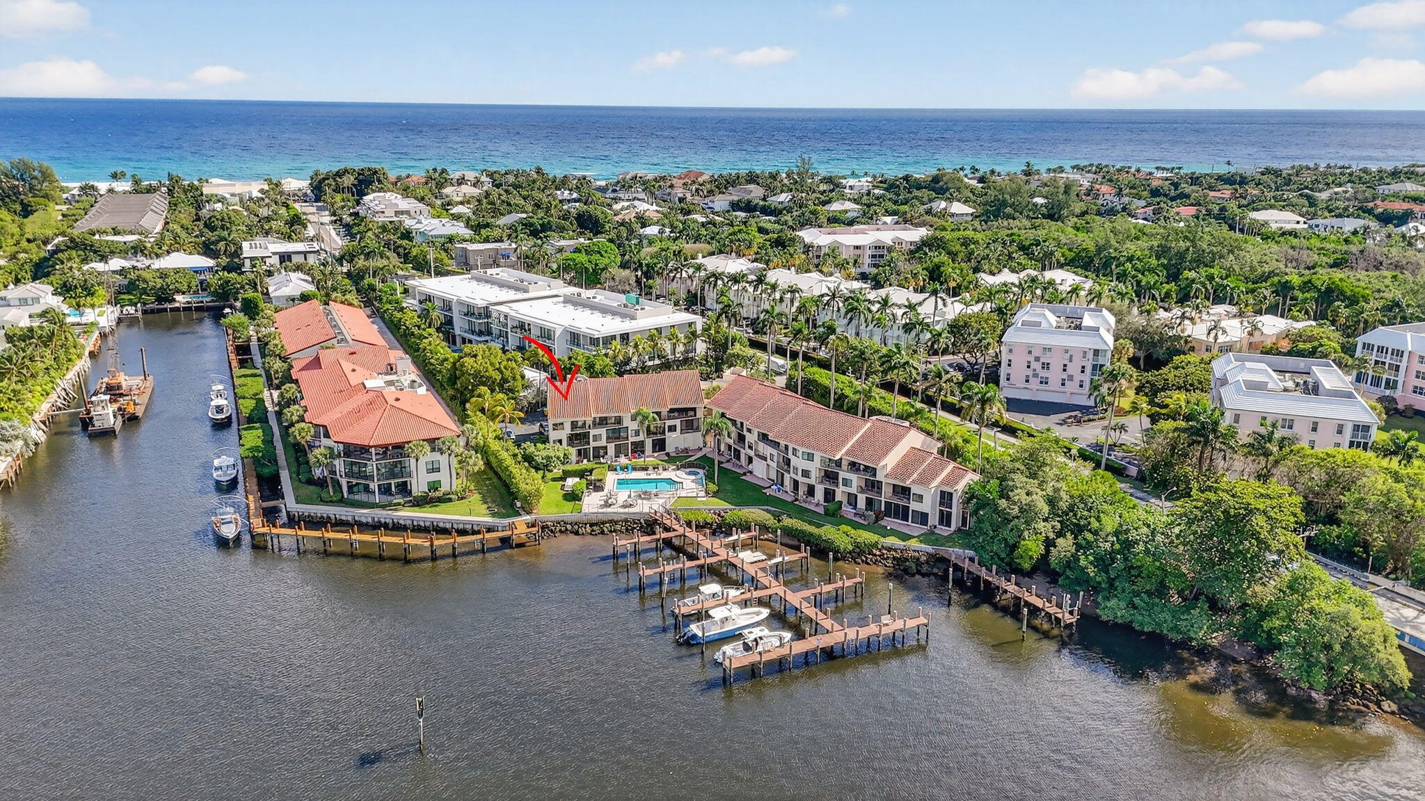 an aerial view of a city with lots of residential buildings ocean and mountain view in back