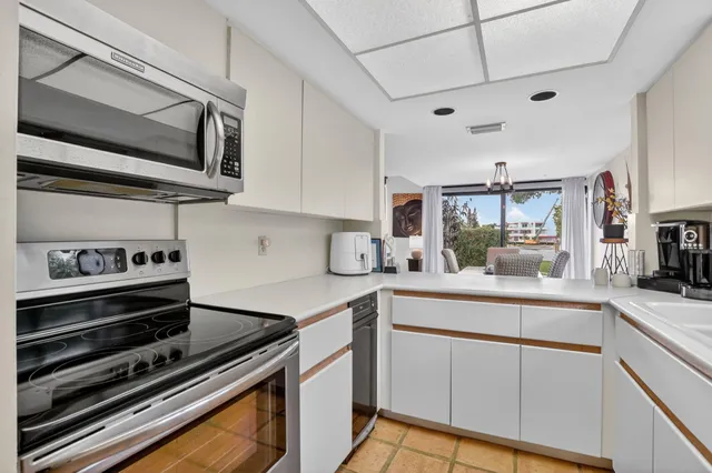 a bedroom with a bed flat screen tv and a large window