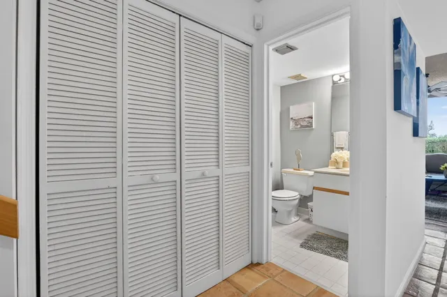 a view of a balcony with wooden floor and outdoor seating