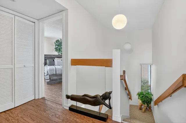 a view of a room with a large window and front door