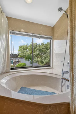 a view of backyard with outdoor seating and plants