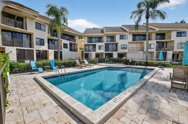 an aerial view of a city with swimming pool and outdoor seating