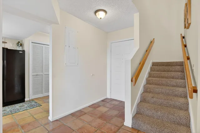 a living room with furniture a flat screen tv and a large window