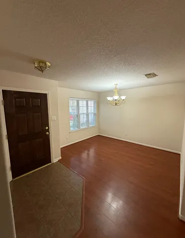an empty room with windows and cabinet