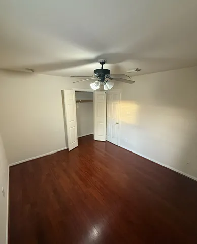 an empty room with a empty space and a ceiling fan