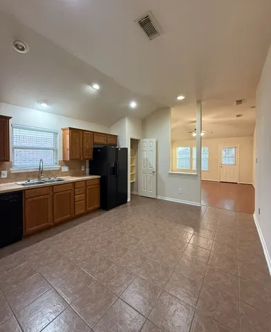 a view of a kitchen with a sink and cabinets