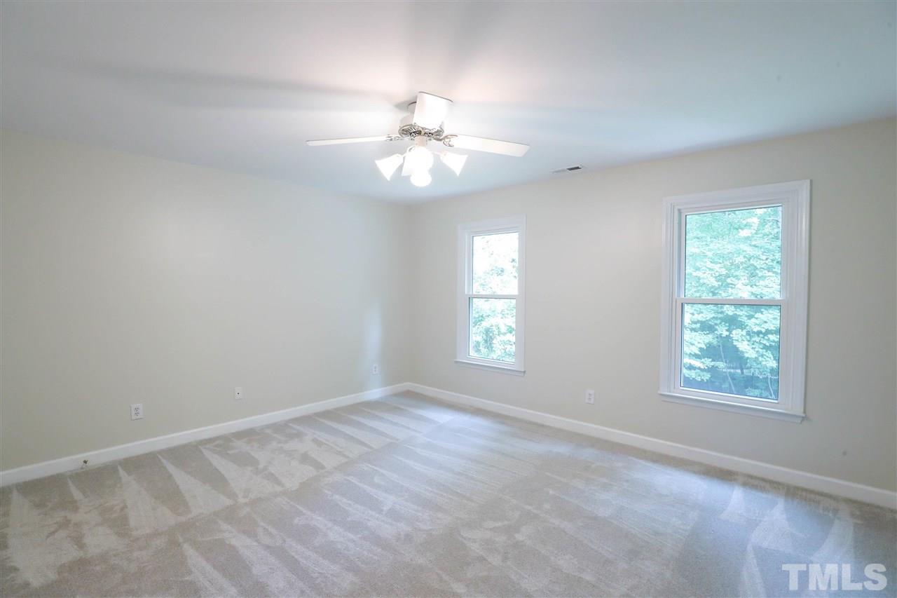 8925 Ball Road Bahama, NC 27503 - Photo 18 of 28 an empty room with windows and fan