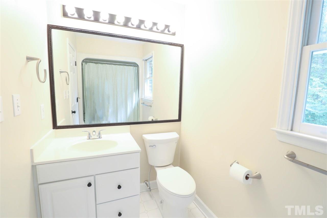 8925 Ball Road Bahama, NC 27503 - Photo 21 of 28 a bathroom with a toilet a sink and mirror
