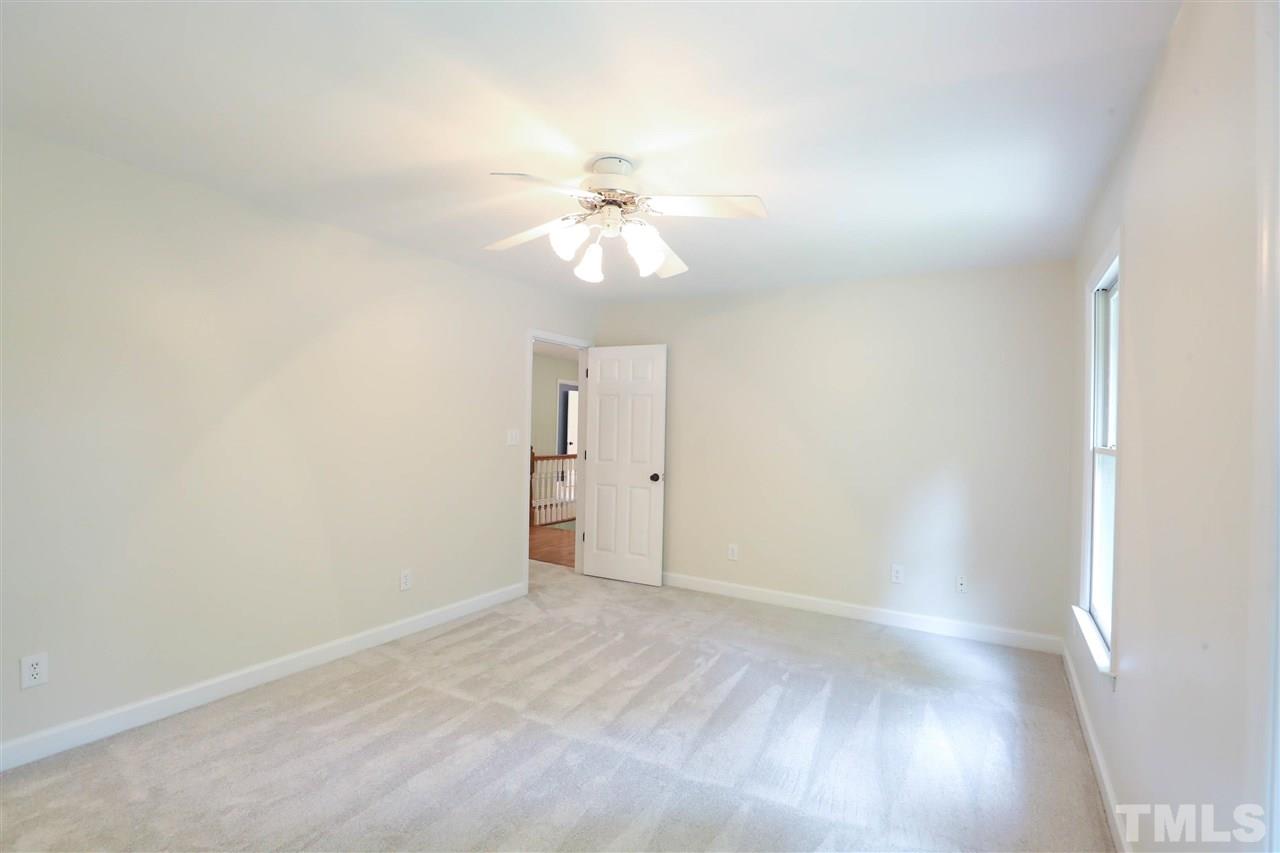 8925 Ball Road Bahama, NC 27503 - Photo 22 of 28 a view of a room with a ceiling fan and a window