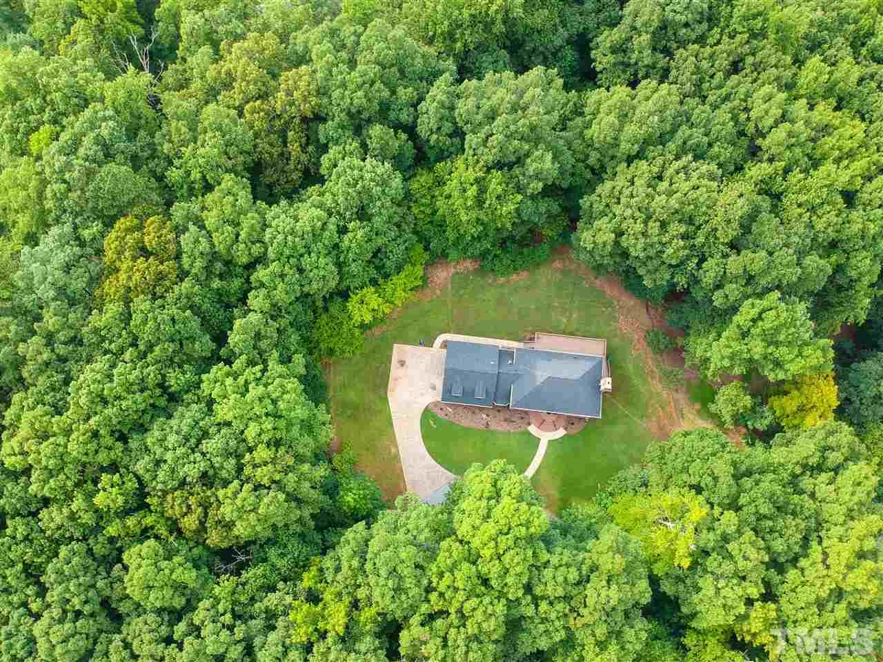 8925 Ball Road Bahama, NC 27503 - Photo 27 of 28 a view of a garden with a bench
