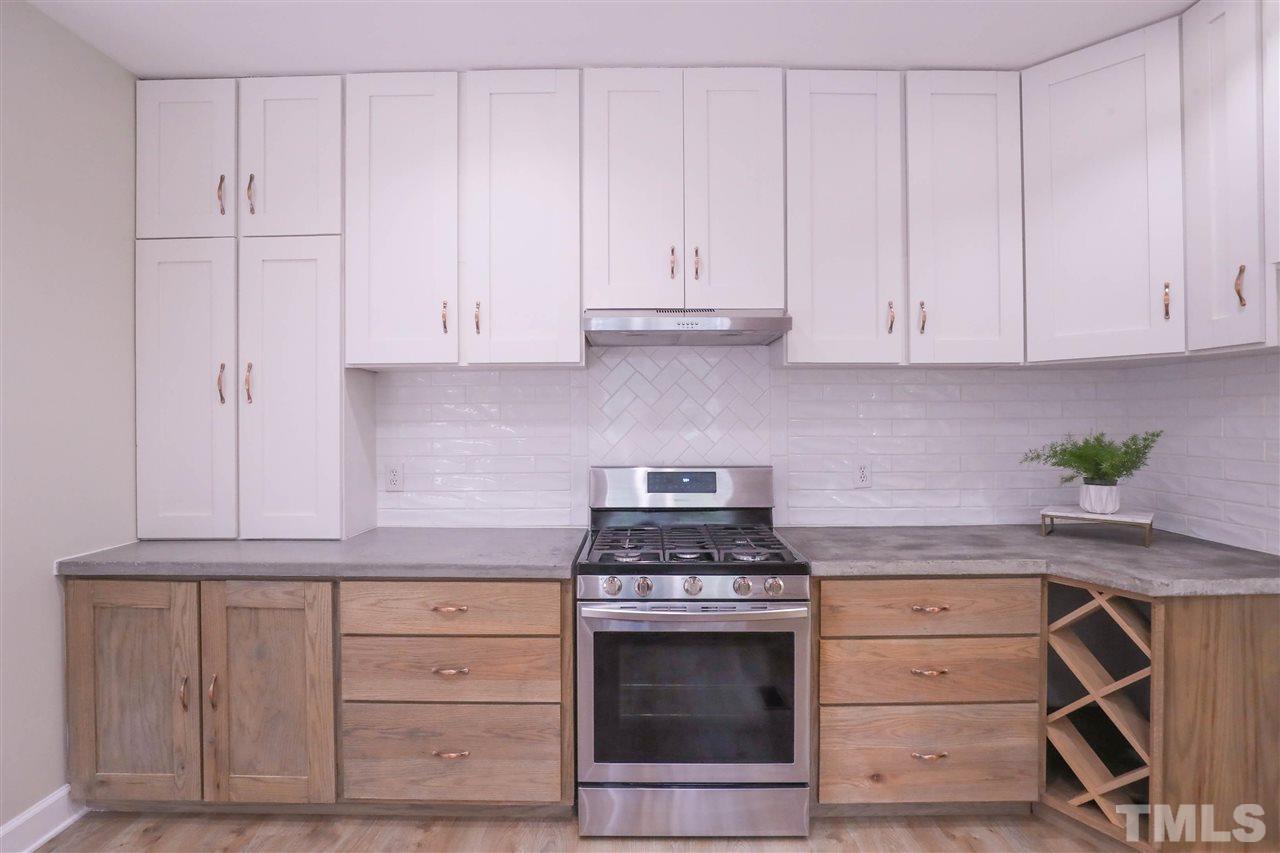 8925 Ball Road Bahama, NC 27503 - Photo 8 of 28 a kitchen with granite countertop white cabinets and stainless steel appliances