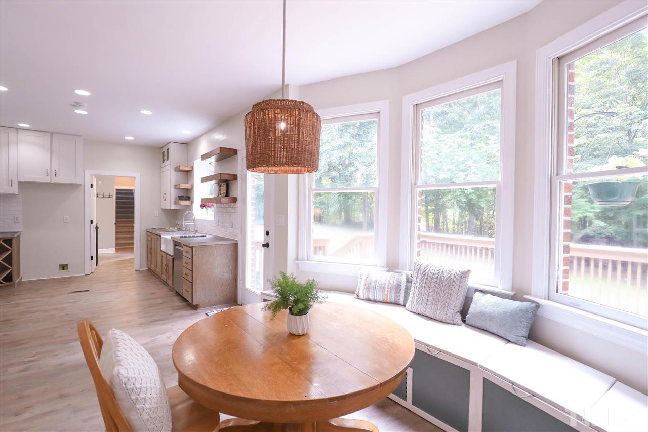 8925 Ball Road Bahama, NC 27503 - Photo 10 of 28 a living room with kitchen island furniture and a view of kitchen
