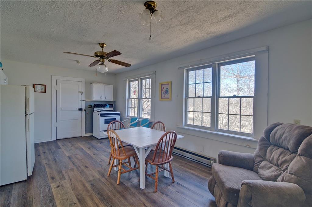 2165 Townsend Mill Road Young Harris, GA 30582 - Photo 13 of 32 a view of a livingroom with furniture window wooden floor and a ceiling fan