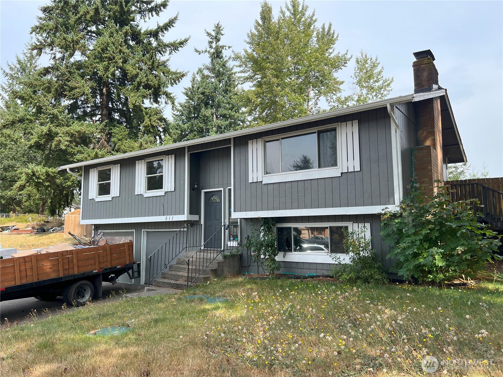 a backyard of a house with yard table and chairs