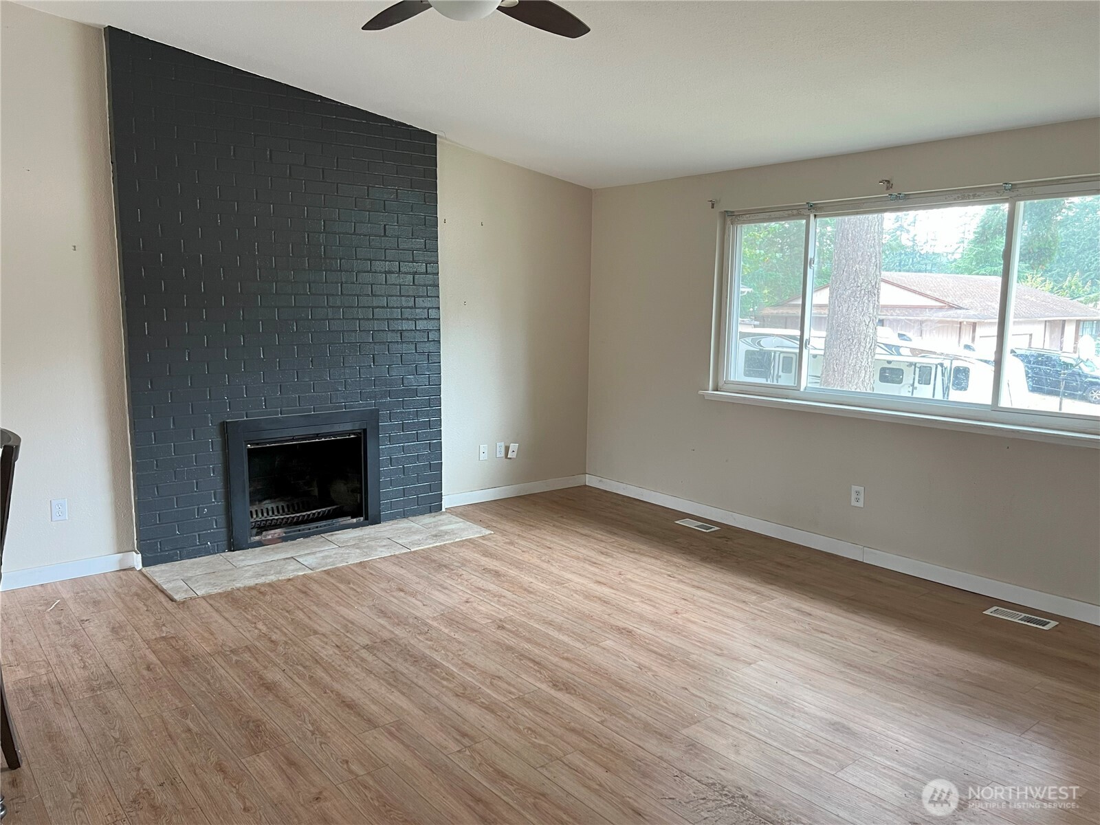 511 190th Street East Spanaway, WA 98387 - Photo 11 of 33 a view of an empty room with a window and fireplace