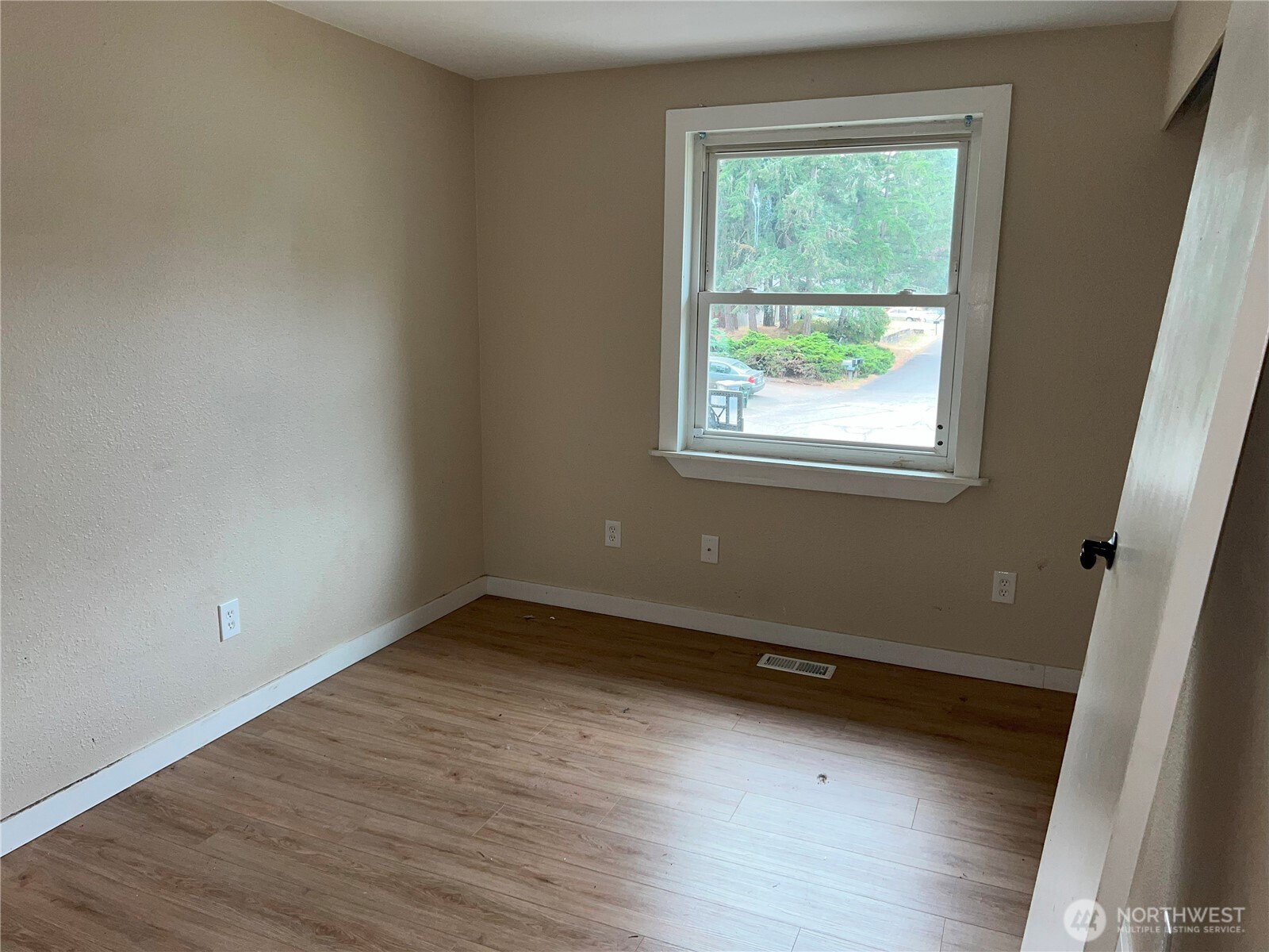 511 190th Street East Spanaway, WA 98387 - Photo 13 of 33 an empty room with wooden floor and windows