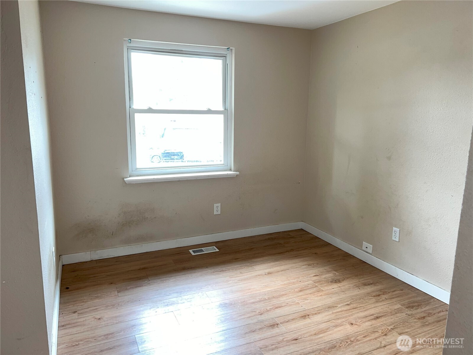 511 190th Street East Spanaway, WA 98387 - Photo 14 of 33 an empty room with wooden floor and windows