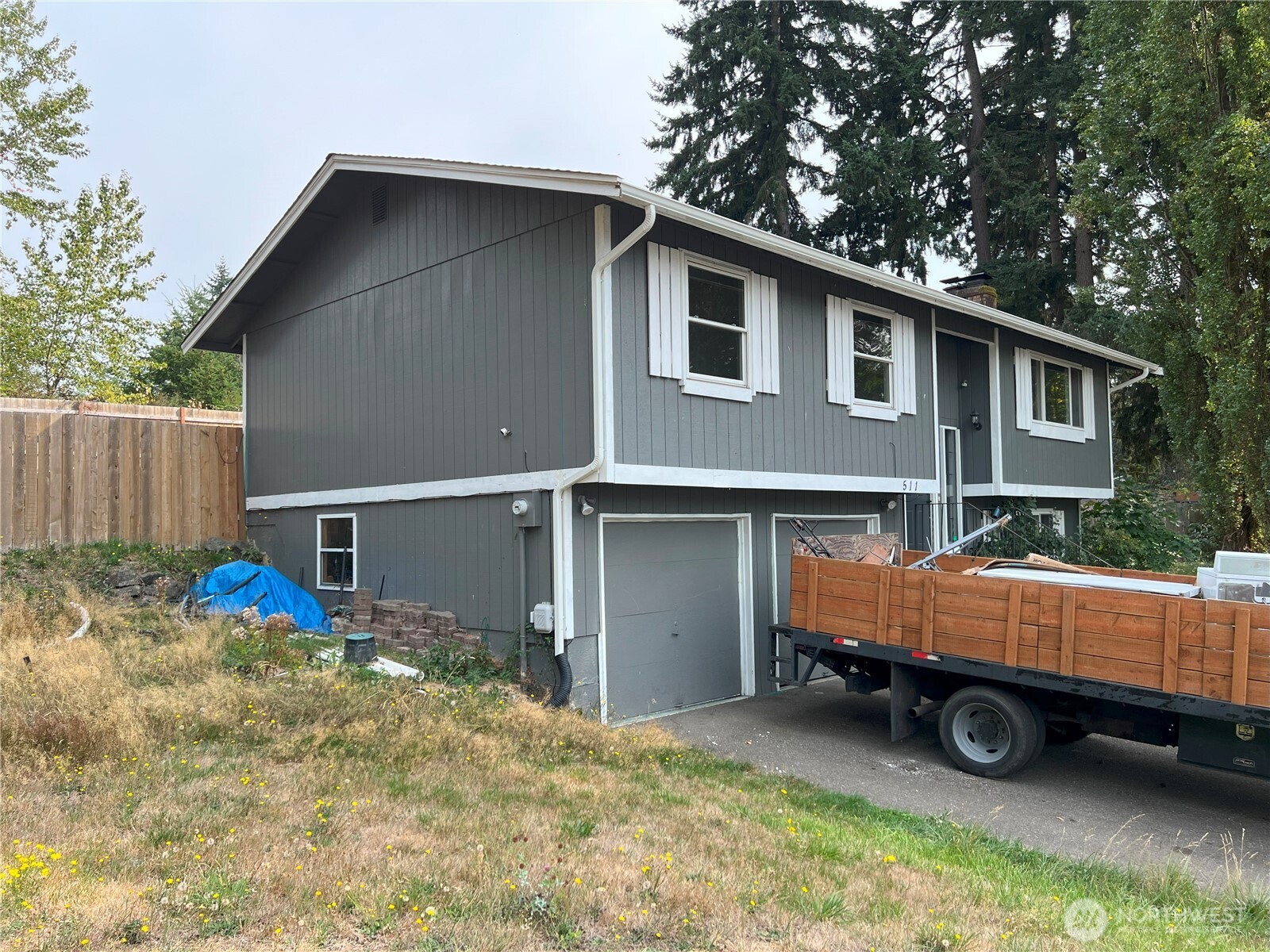 511 190th Street East Spanaway, WA 98387 - Photo 2 of 33 a backyard of a house with barbeque oven and outdoor seating